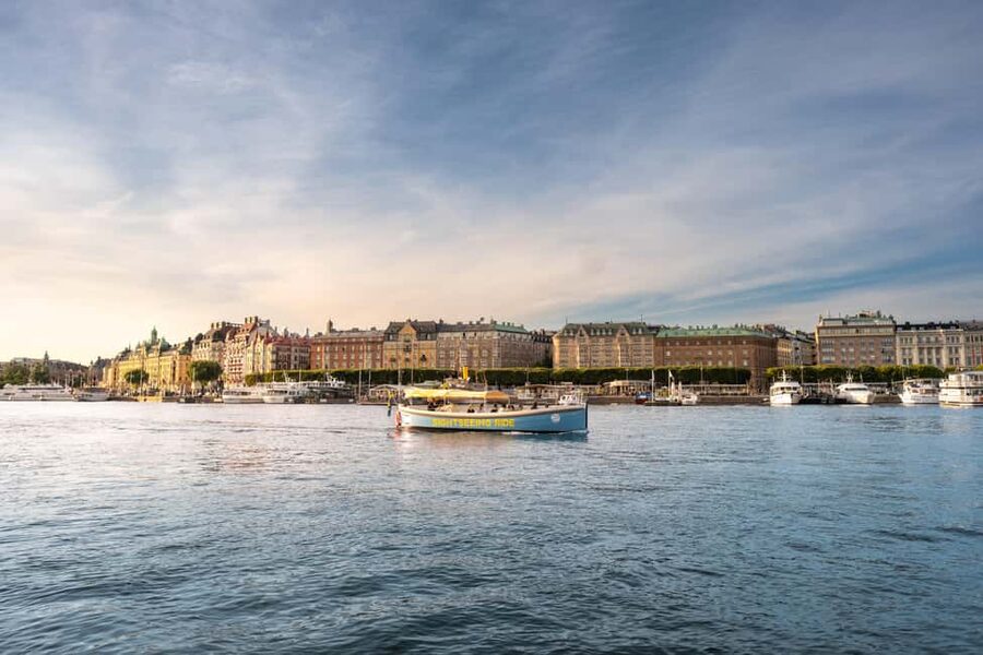 Stockholm: Guided City Sightseeing Open Electric Boat Tour - Board at the blue boat by the Royal Palace